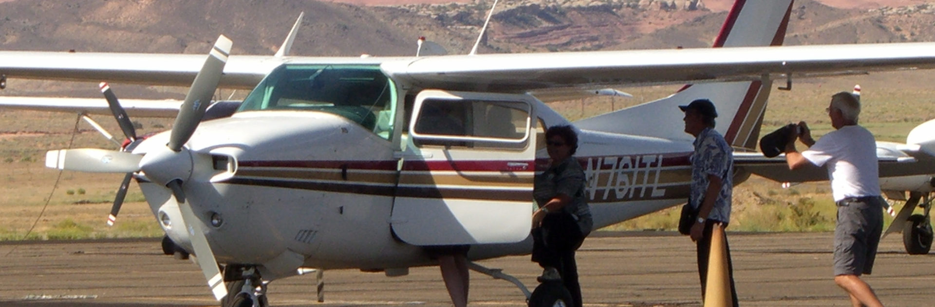 Three people boarding a white airplane