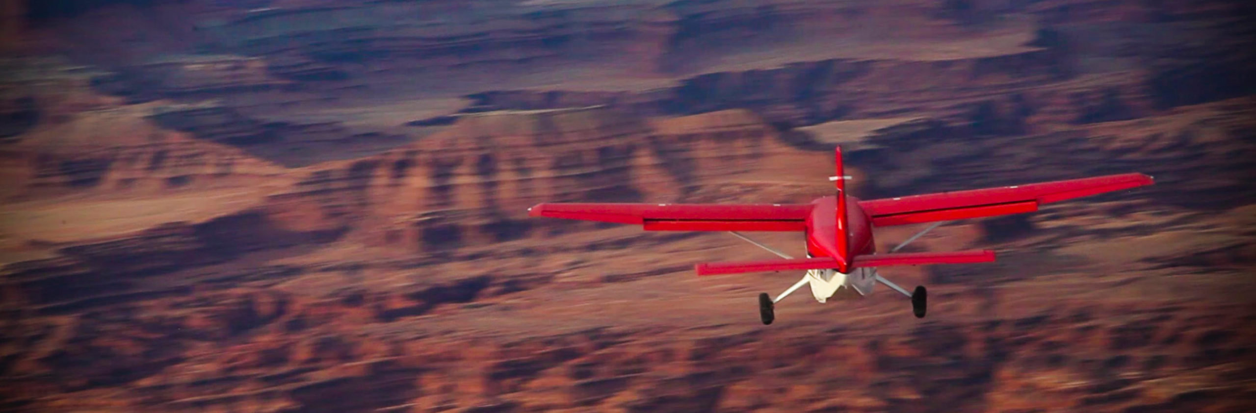 red airplane tour flying in moab