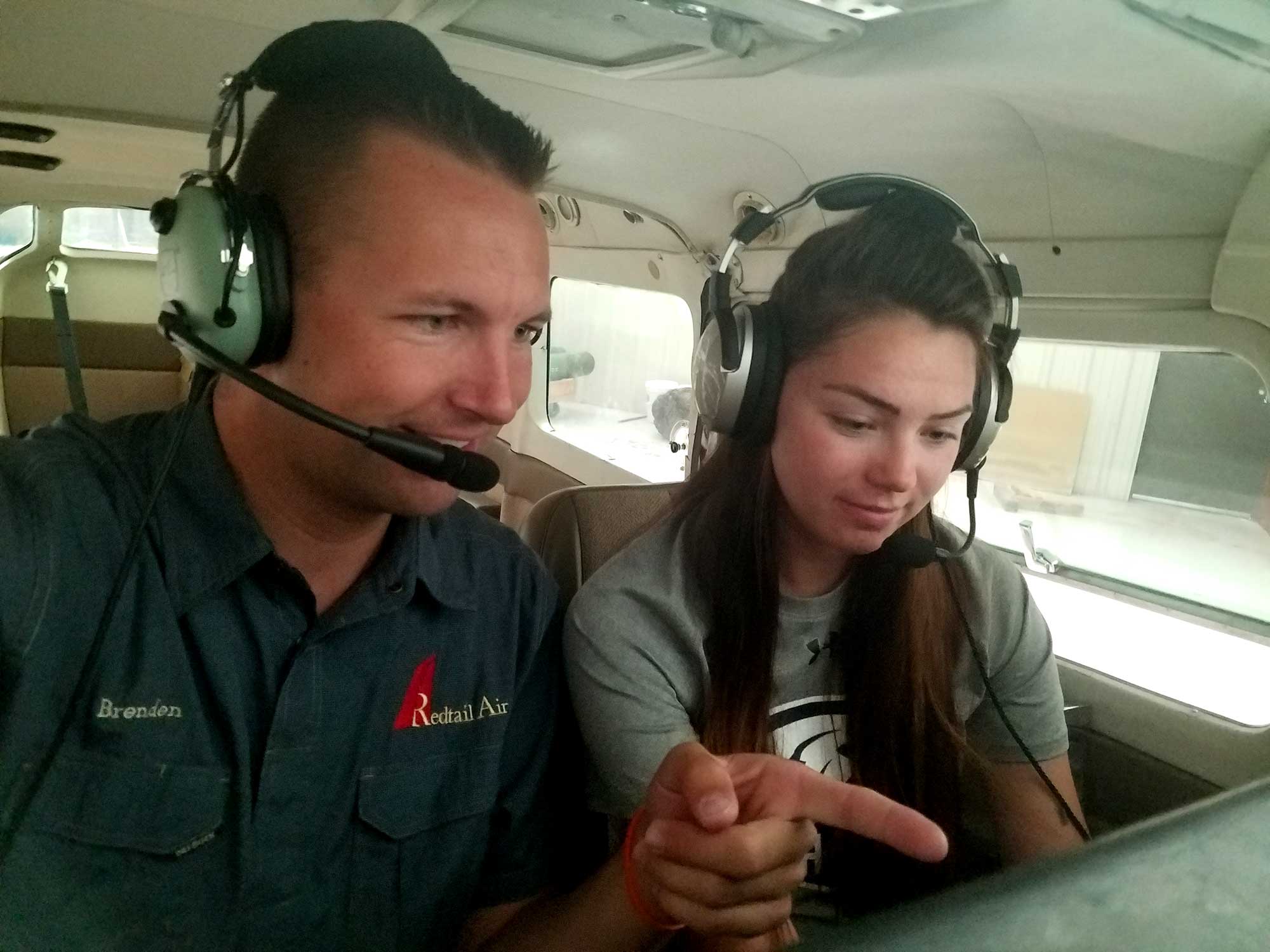 Flight instructor helping student