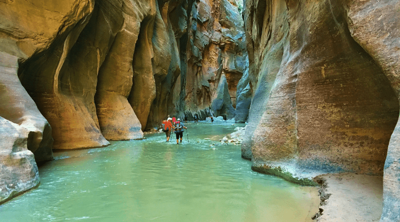 couple hiking the Narrow in Zion National Park for adventurous couples getaway to Utah National Park