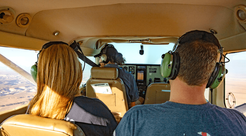 couple on scenic flight over rocky mountains