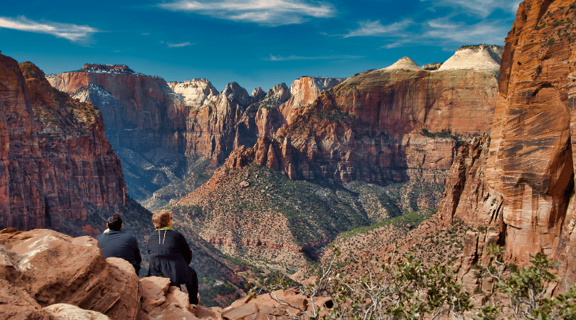 two people looking out at zion national park