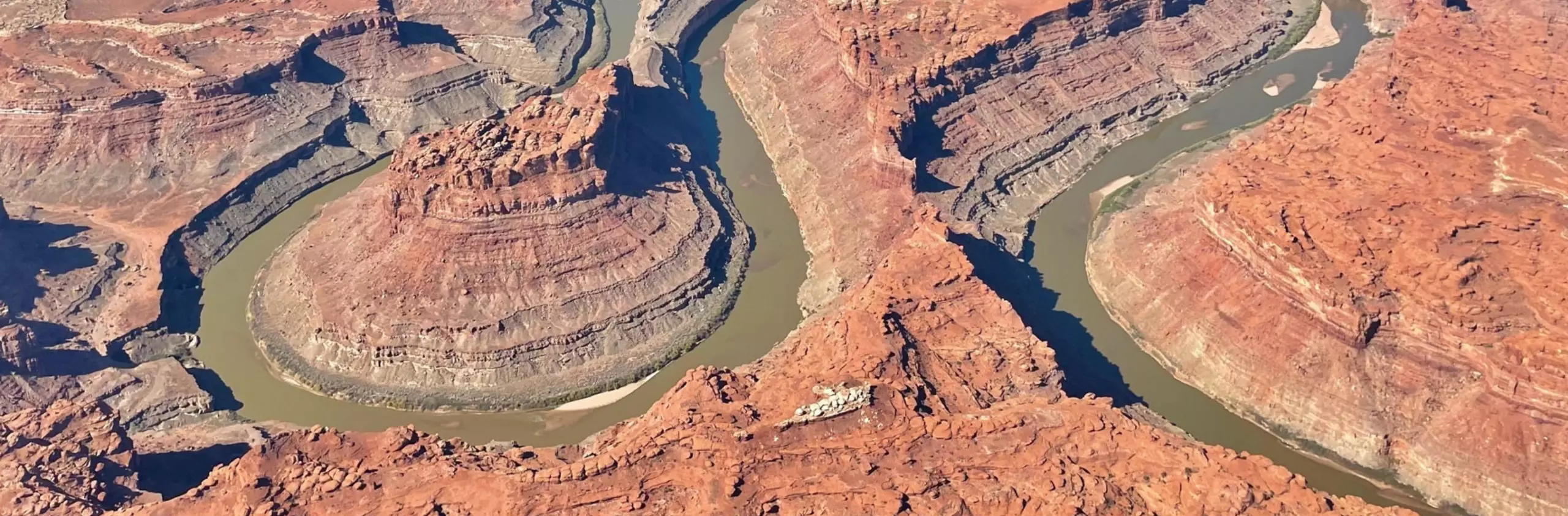 bird's eye view of a river through canyonlands