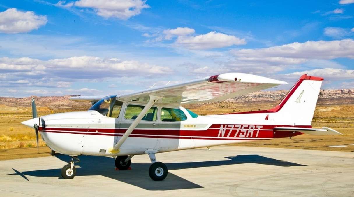 red and white cessna plane on the runway