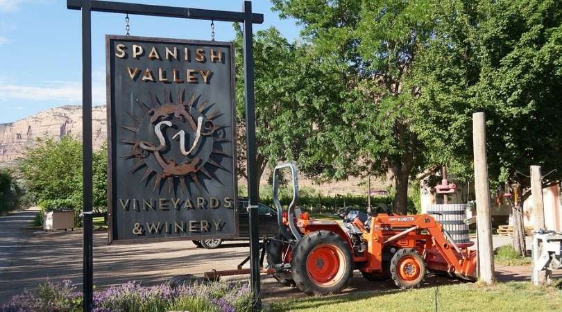 a tractor and sign for spanish valley winery