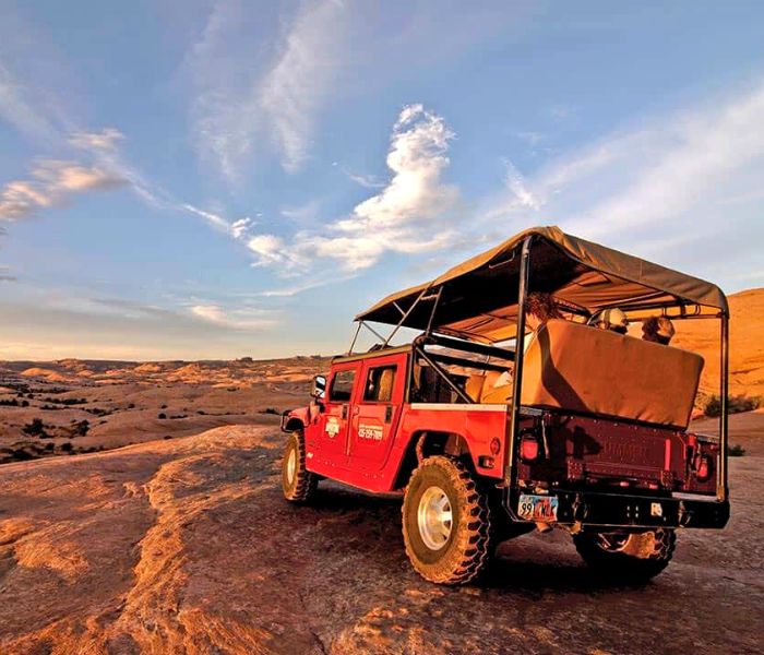 red jeep at sunset in the desert