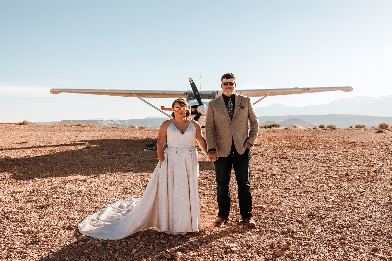 couple holding hands and looking at the camera during their backcountry elopement