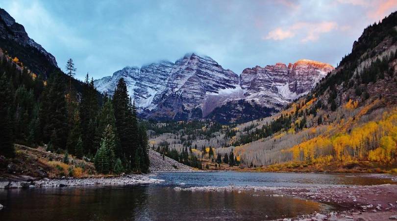 dusky light of a lake a snow-capped mountains in colorado