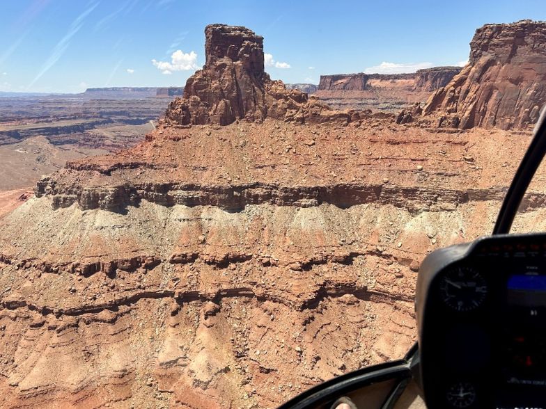 view of rock tower above canyon from a helicopter tour