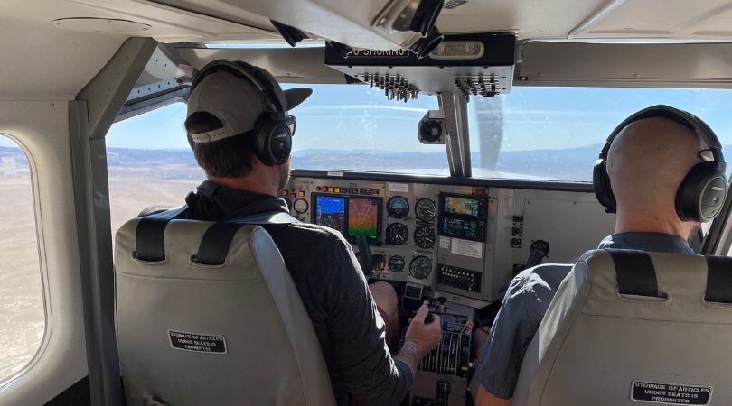 instructor and student flying a single-engine plane