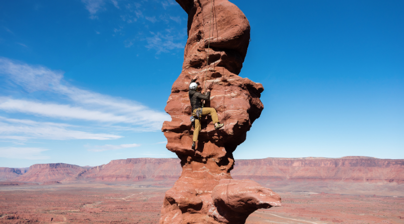 rock climber in moab in the fall