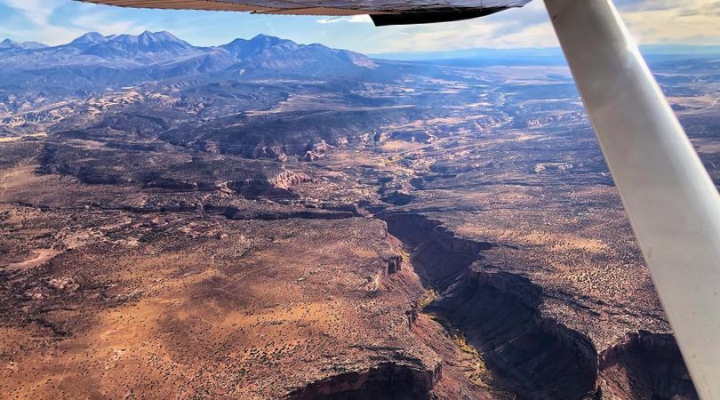 view from an airplane flying over canyonlands national park