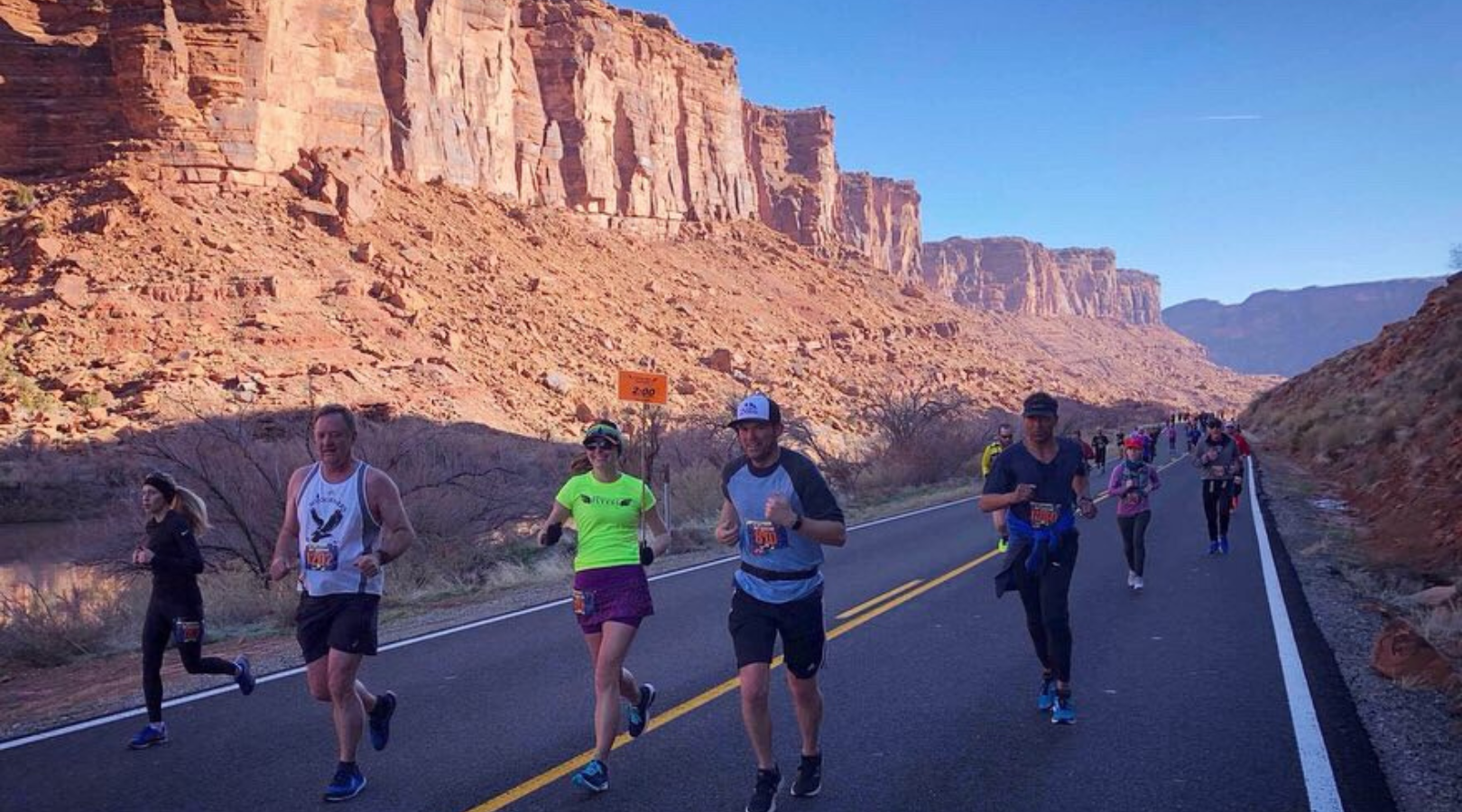 marathoners running through moab's red rock canyons