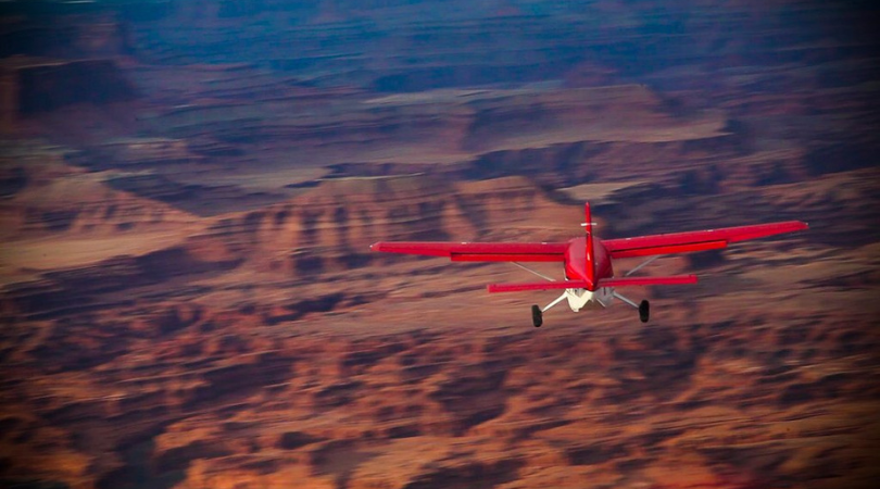 redtail air plane flying over canyons near moab utah