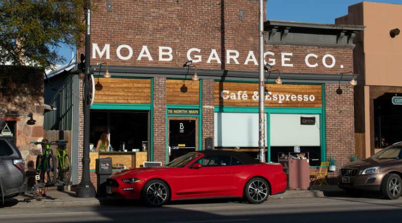 moab garage co storefront with red car rental parked in front