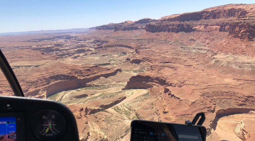 view from the front of a helicopter tour of the canyons below