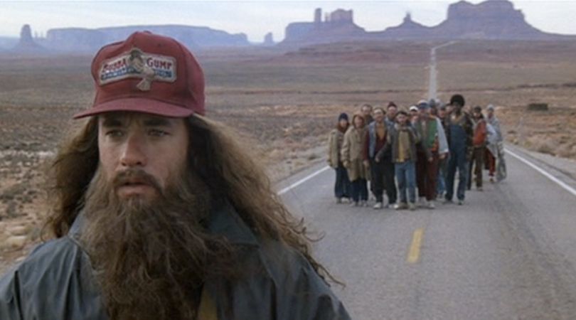 scene from the film "Forrest Gump" shows the main character and a group of fans running down a highway in the Utah desert