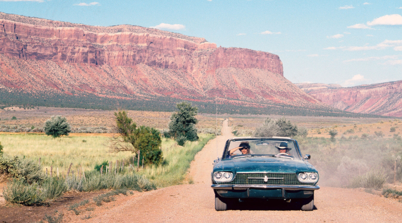 thelma and louise driving down a dirt road at the filming location in moab