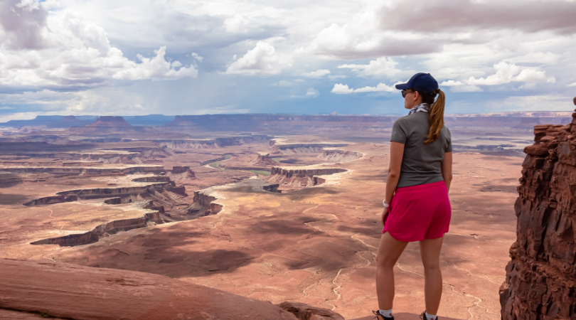 woman enjoying the views at the end of a hike in canyonlands national park